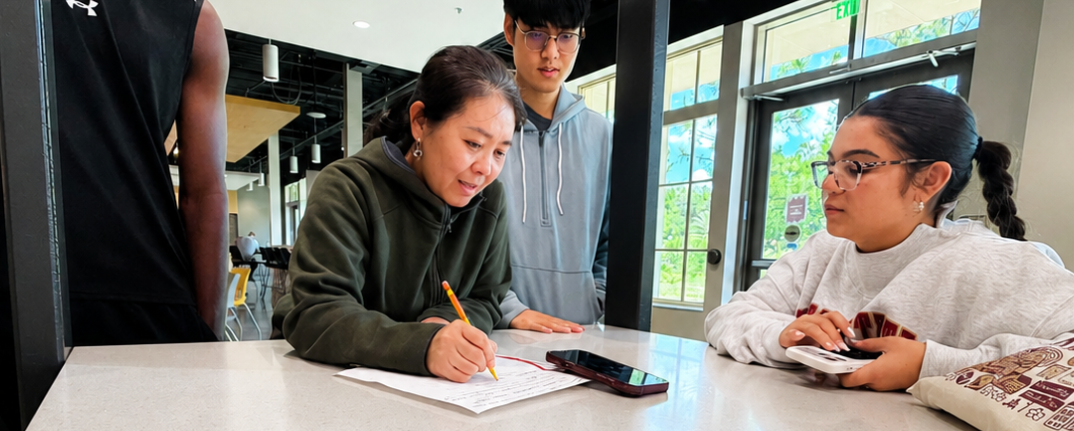 CIES student named Tam taking notes.
