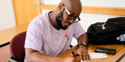 Student named Amaure taking notes.
