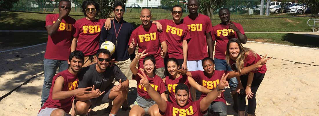 Group of students wearing FSU shirts playing volleyball